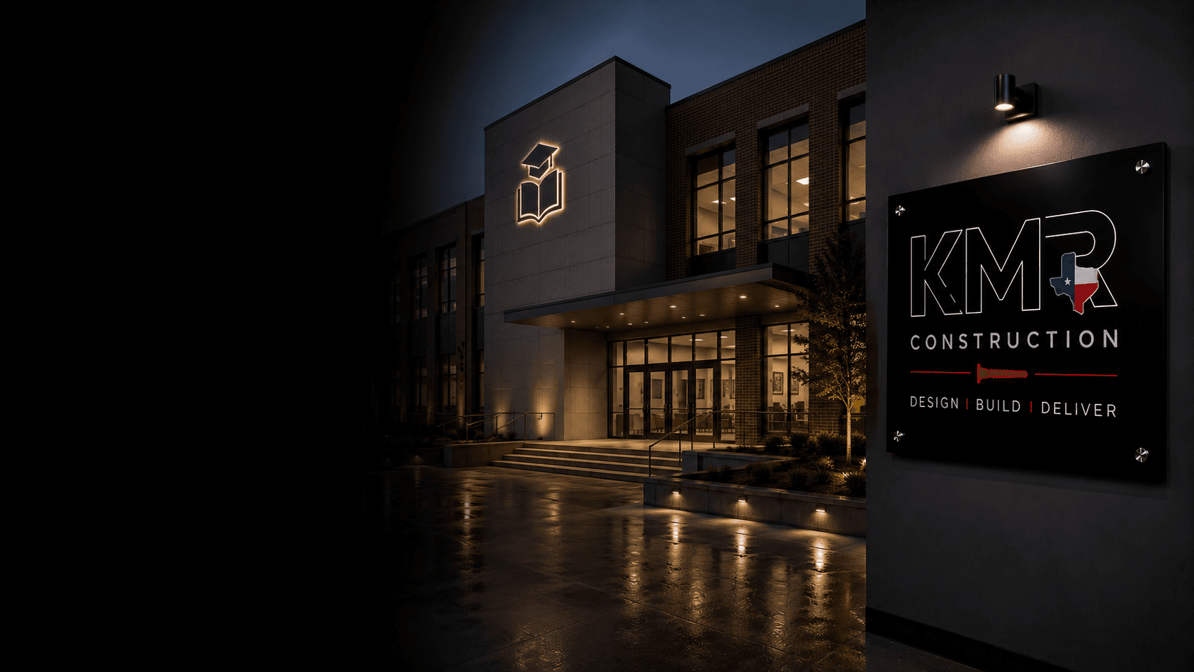 KMR-built school exterior with illuminated book icon and KMR signage at twilight