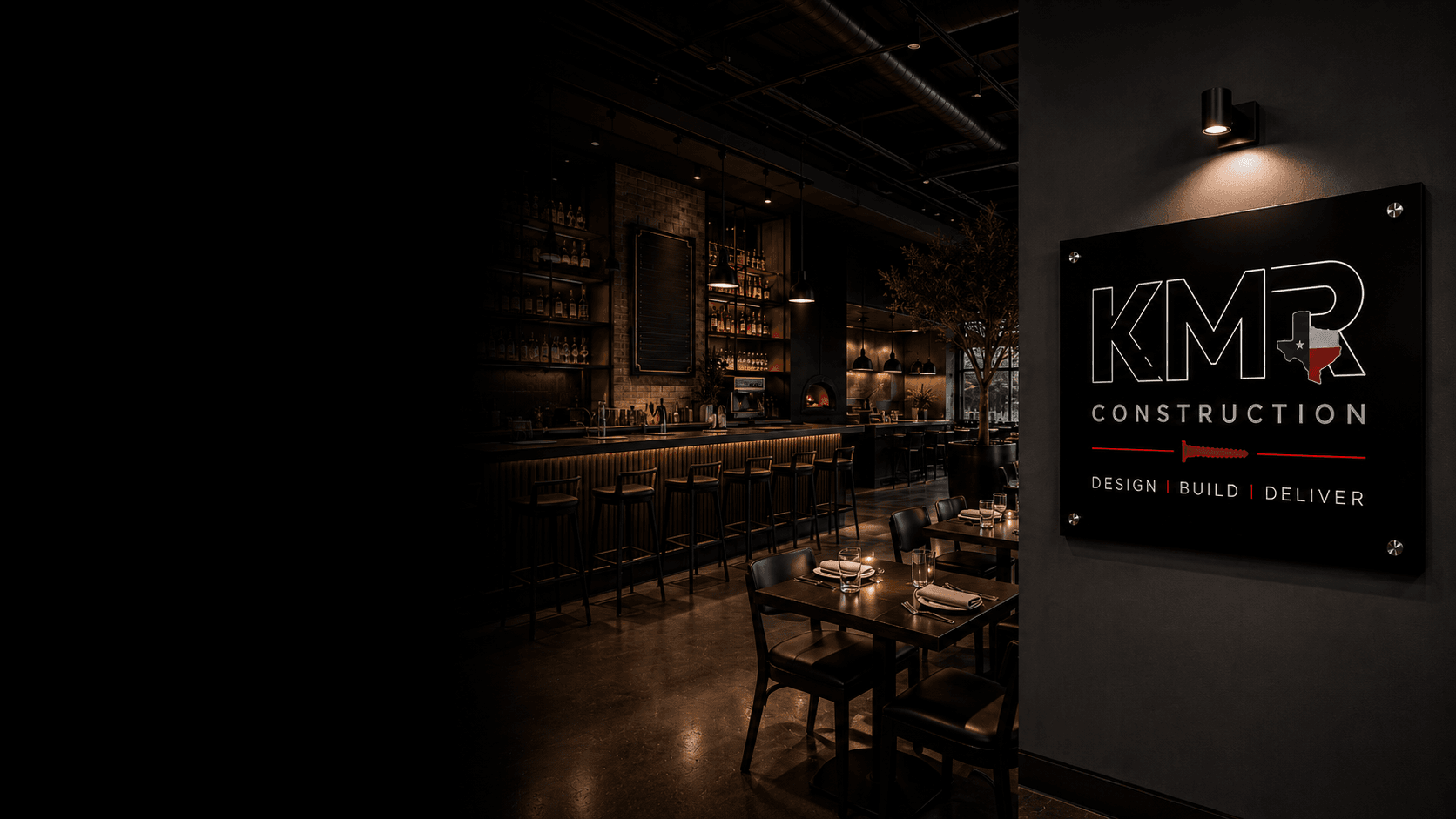 KMR-built restaurant interior with bar, dining tables, and KMR signage at twilight